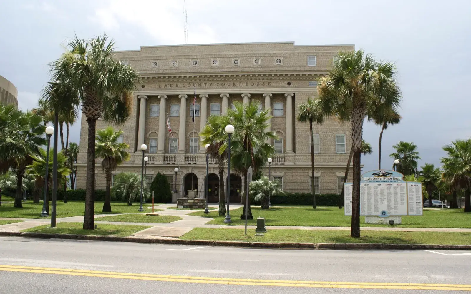 Historic Lake County courthouse framed by palm trees in Tavares, FL