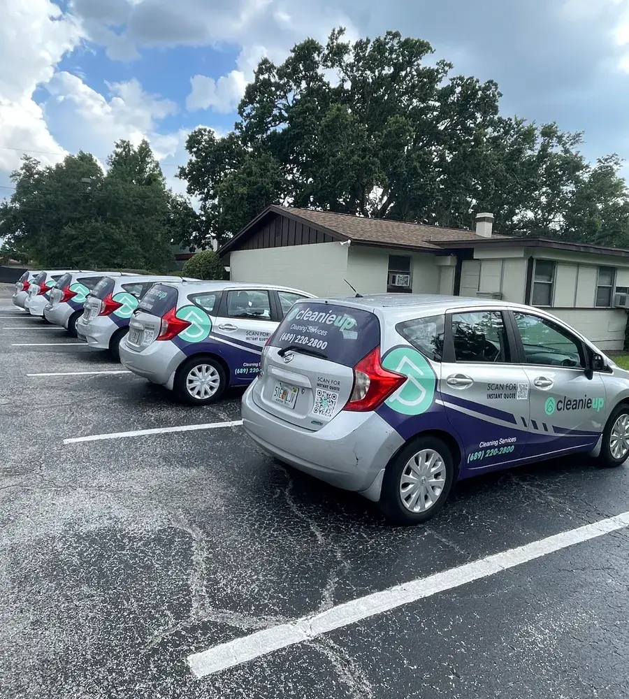 Row of branded CleanieUp cleaning cars ready for the day's house cleanings around Winter Garden, FL