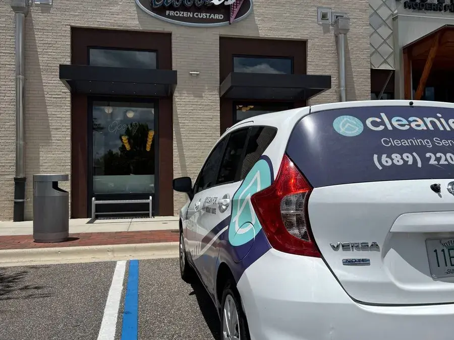 CleanieUp car outside a shopping plaza storefront, arriving for a commercial cleaning in Winter Garden, FL