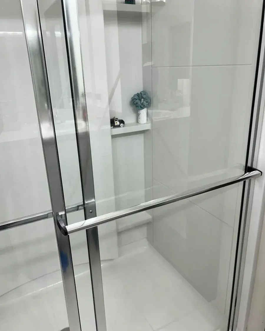 Glass shower door and chrome handle wiped streak-free after a biweekly house cleaning in Clermont, FL