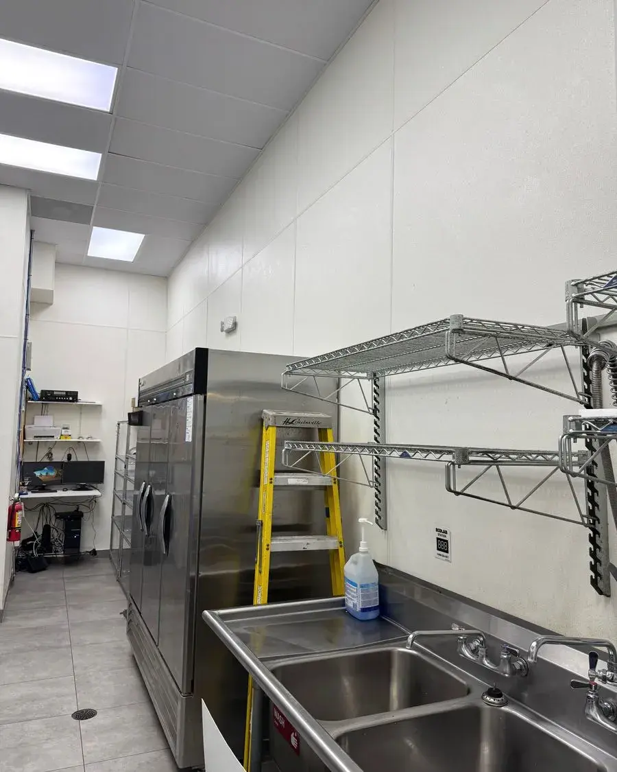 Back room with metal shelving and a stepladder during a commercial cleaning in Clermont, FL