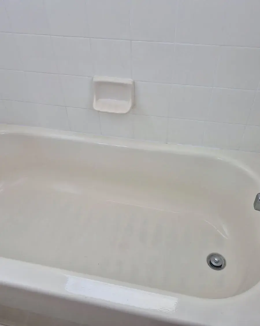 Clean bathtub with tiled walls and a polished faucet after a monthly house cleaning in Clermont, FL