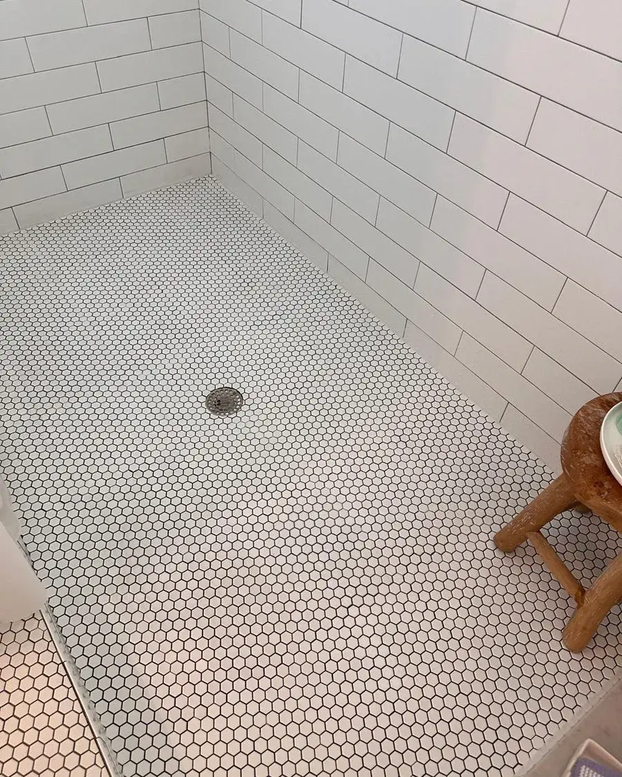 Hexagon tile shower floor scrubbed clean after a weekly house cleaning in Clermont, FL