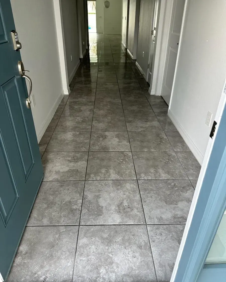 Empty tiled hallway with a teal front door after a move-out cleaning in Dr. Phillips, FL