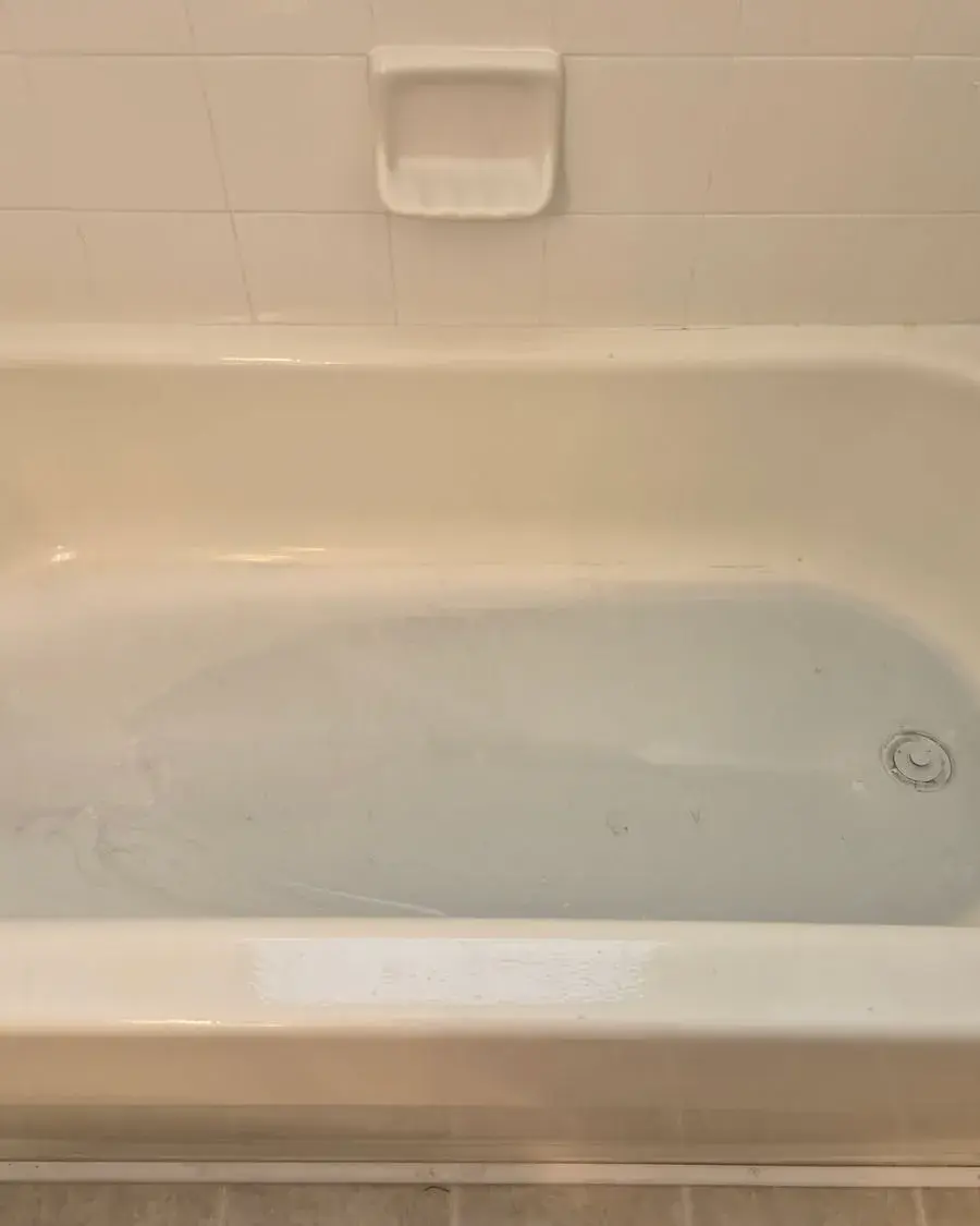 Clean bathtub with a built-in soap dish after a monthly house cleaning in Ferndale, FL