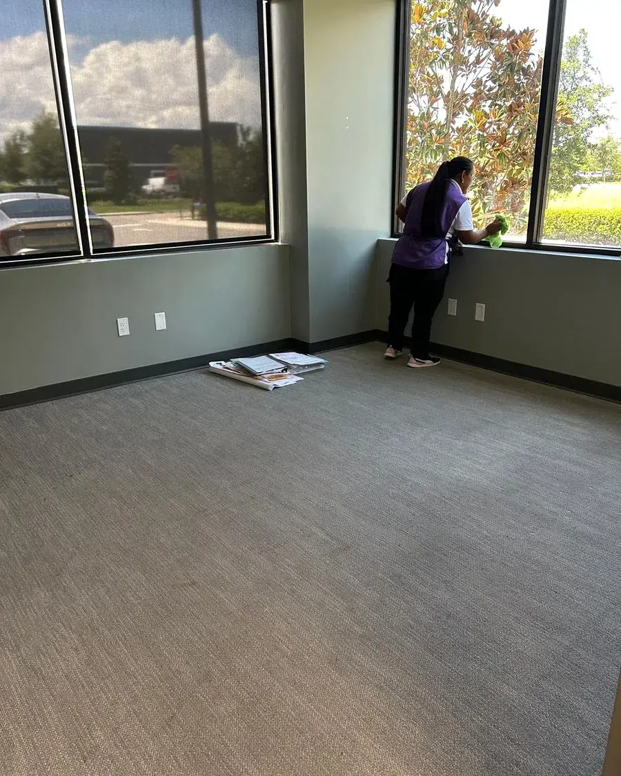 CleanieUp cleaner wiping office windows during a commercial cleaning in Horizon West, FL