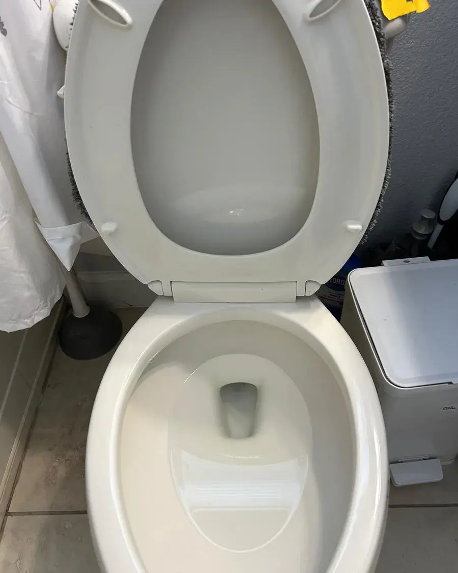 Spotless toilet bowl and seat in a freshly cleaned bathroom after a biweekly house cleaning in Minneola, FL