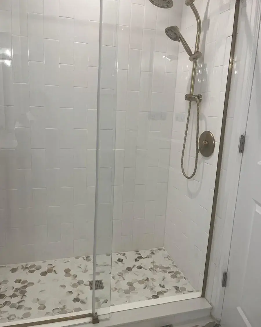 White tile shower with a handheld shower head scrubbed during a deep cleaning in Minneola, FL