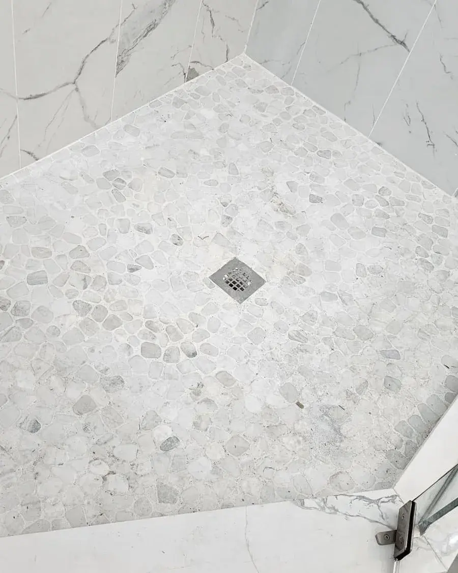 Marble-look shower floor with a clean drain after a monthly house cleaning in Montverde, FL