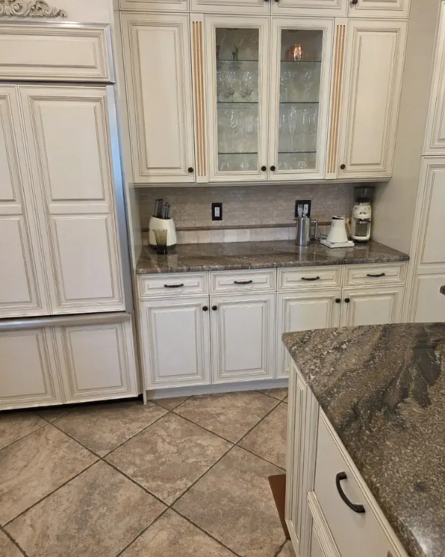 Kitchen with cream cabinets and granite counters after a biweekly house cleaning in Ocoee, FL