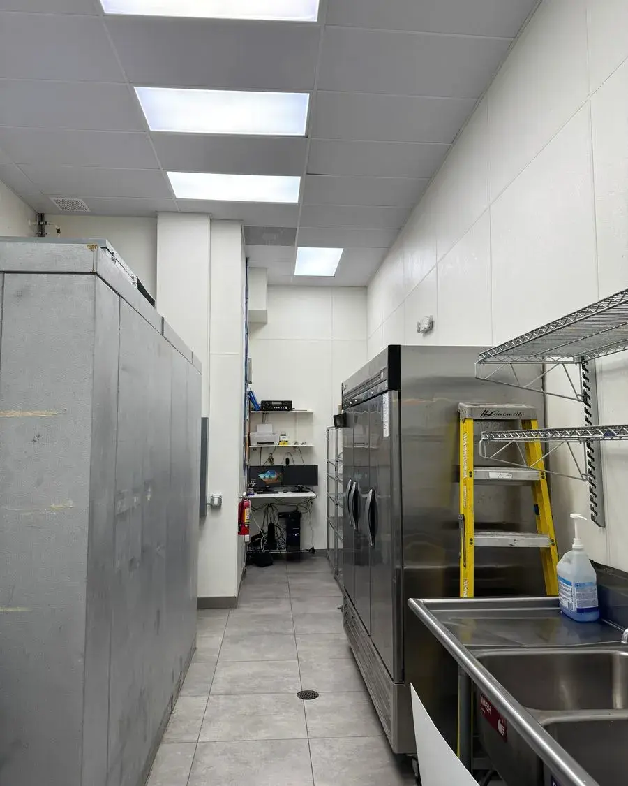 Back-of-house room with stainless freezers and shelving during a commercial cleaning in Ocoee, FL
