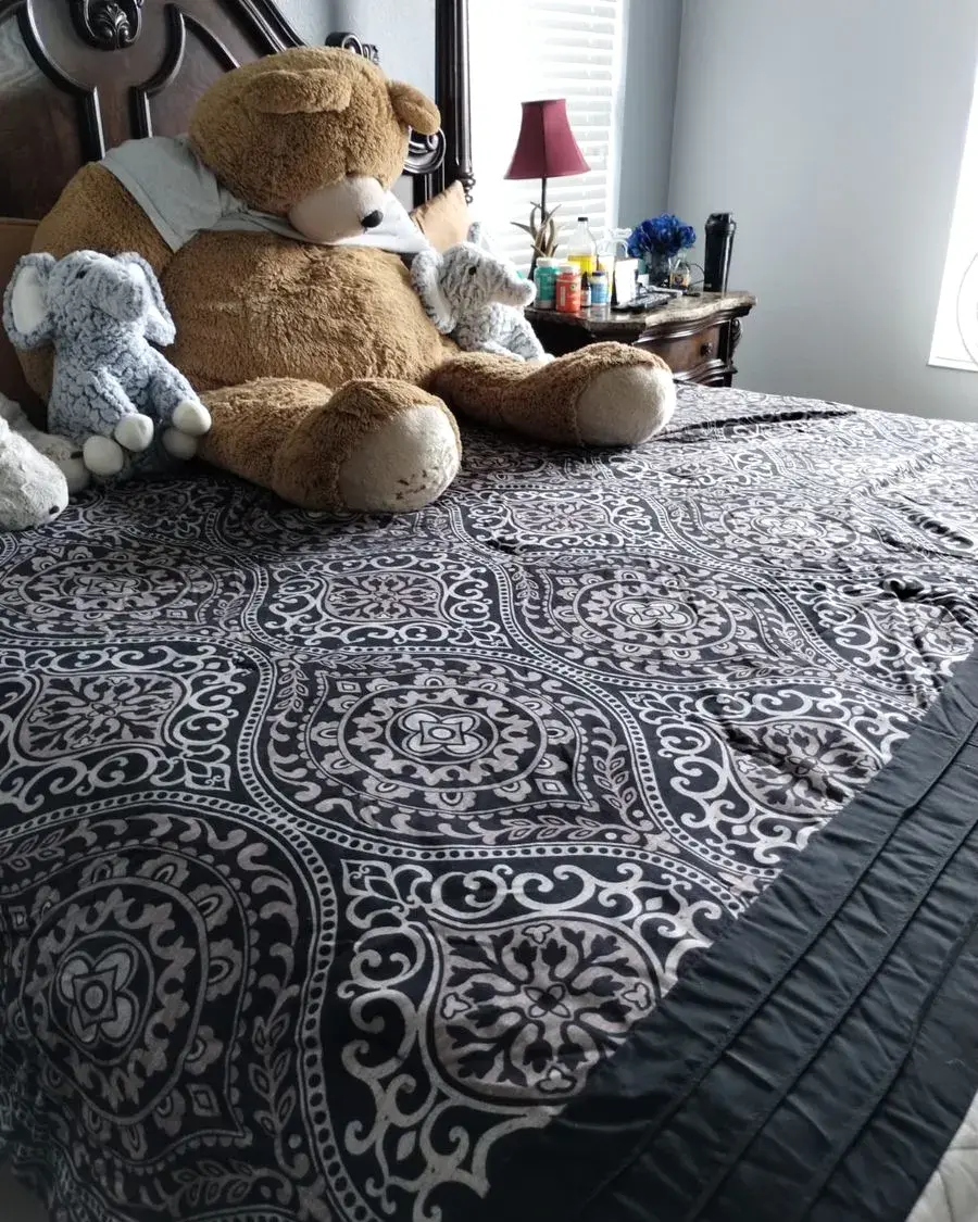 Neatly made bed with plush toys in a family home after a biweekly cleaning in Winter Garden, FL