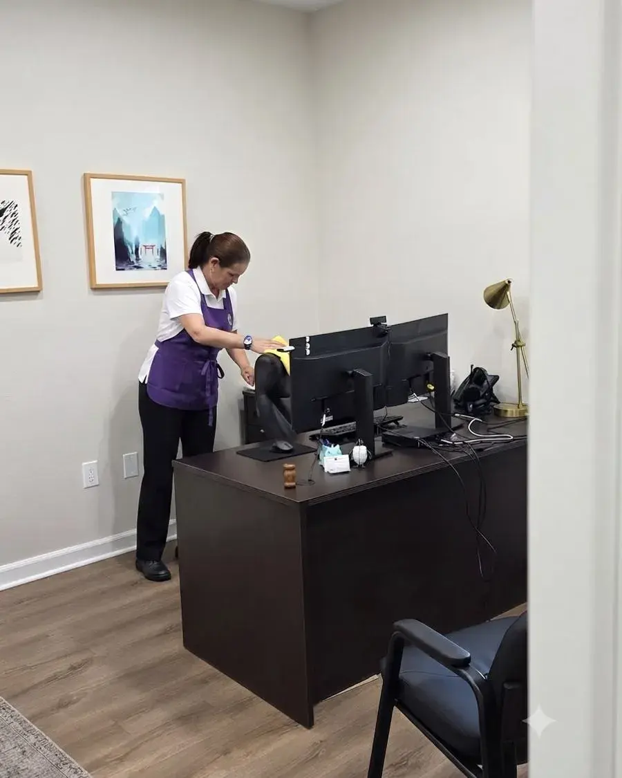 CleanieUp cleaner dusting an office desk and workstation in Winter Garden, FL