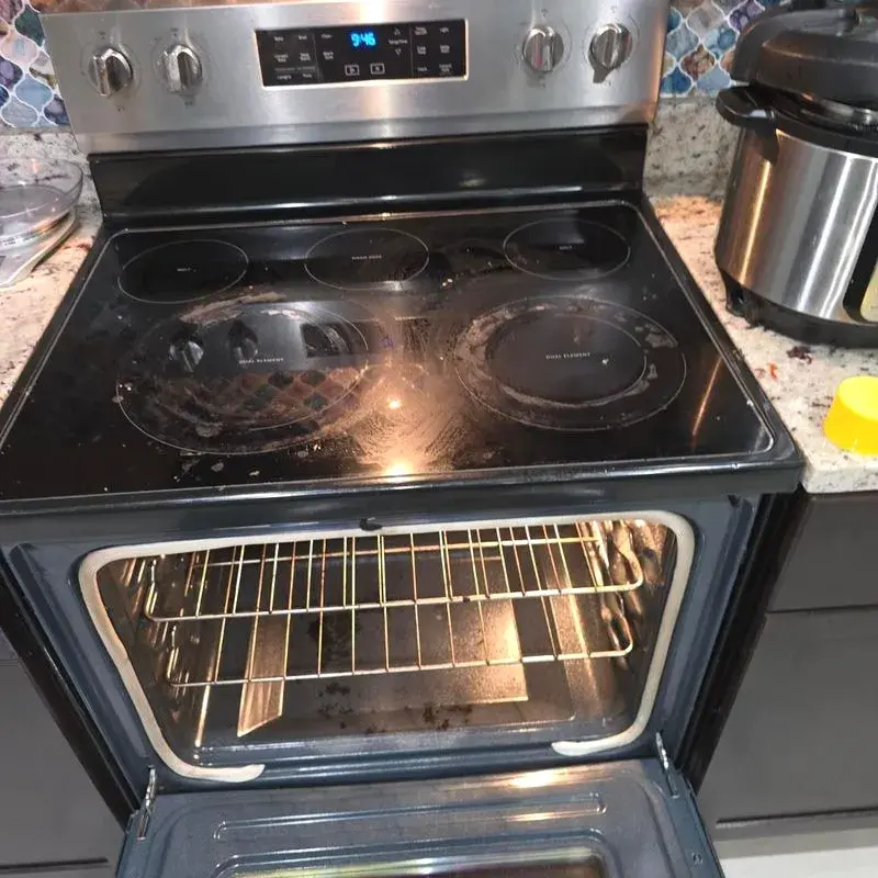 Smudged glass stovetop before a CleanieUp deep cleaning in Winter Garden, FL
