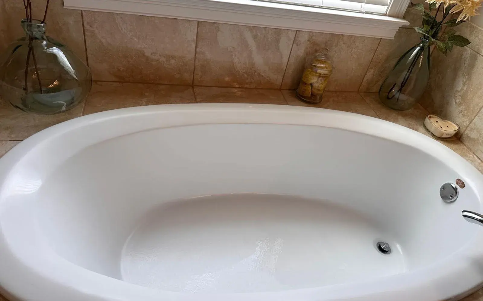 Spotless soaking tub below a bright window after a monthly cleaning in Winter Garden, FL