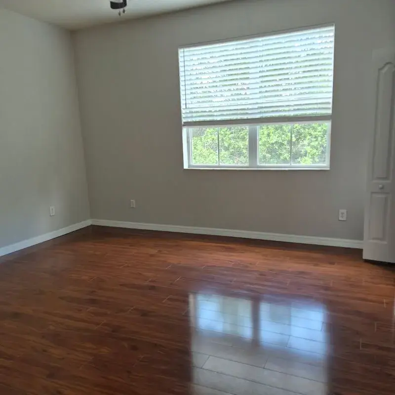 Empty bedroom with freshly cleaned hardwood floors after a CleanieUp move cleaning in Winter Garden, FL Empty bedroom with freshly cleaned hardwood floors after a CleanieUp move cleaning in Winter Garden, FL