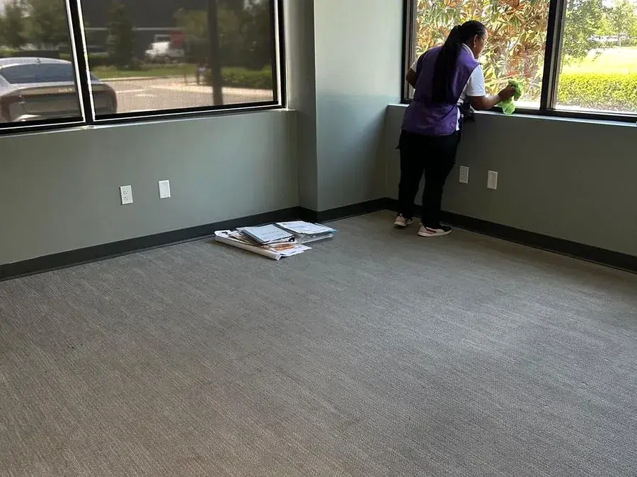 CleanieUp team member wiping office windows, an example of CleanieUp commercial cleaning in Winter Garden, FL CleanieUp team member wiping office windows, an example of CleanieUp commercial cleaning in Winter Garden, FL