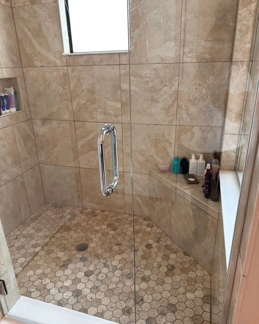 Walk-in shower with beige tile and a clean glass door after a biweekly house cleaning in Dr. Phillips, FL Walk-in shower with beige tile and a clean glass door after a biweekly house cleaning in Dr. Phillips, FL