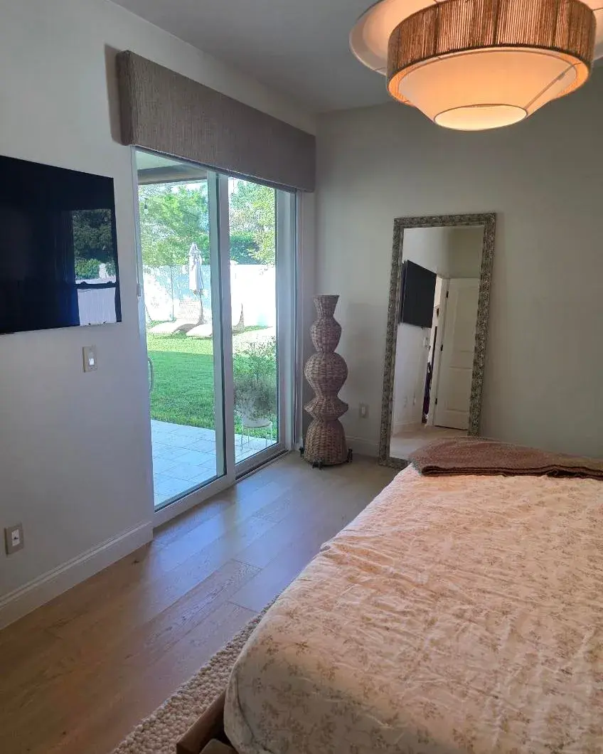 Bedroom with a sliding glass door and freshly cleaned floors after a monthly house cleaning in Horizon West, FL Bedroom with a sliding glass door and freshly cleaned floors after a monthly house cleaning in Horizon West, FL