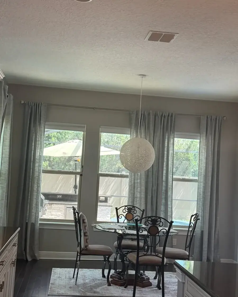 Dining nook with a round pendant light and tall windows after a biweekly house cleaning in Windermere, FL Dining nook with a round pendant light and tall windows after a biweekly house cleaning in Windermere, FL