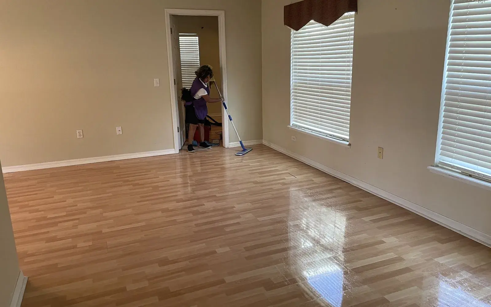 CleanieUp cleaner finishing an empty room with gleaming wood floors for a move-out cleaning in Winter Garden, FL CleanieUp cleaner finishing an empty room with gleaming wood floors for a move-out cleaning in Winter Garden, FL