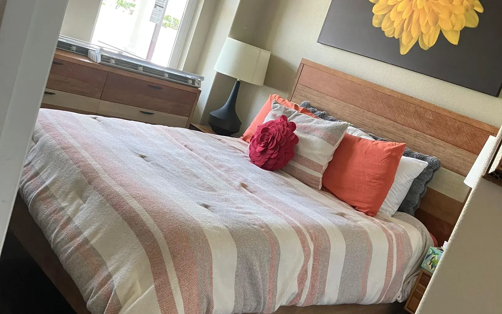 Freshly made bed with striped comforter and bright pillows after a weekly cleaning in Winter Garden, FL Freshly made bed with striped comforter and bright pillows after a weekly cleaning in Winter Garden, FL